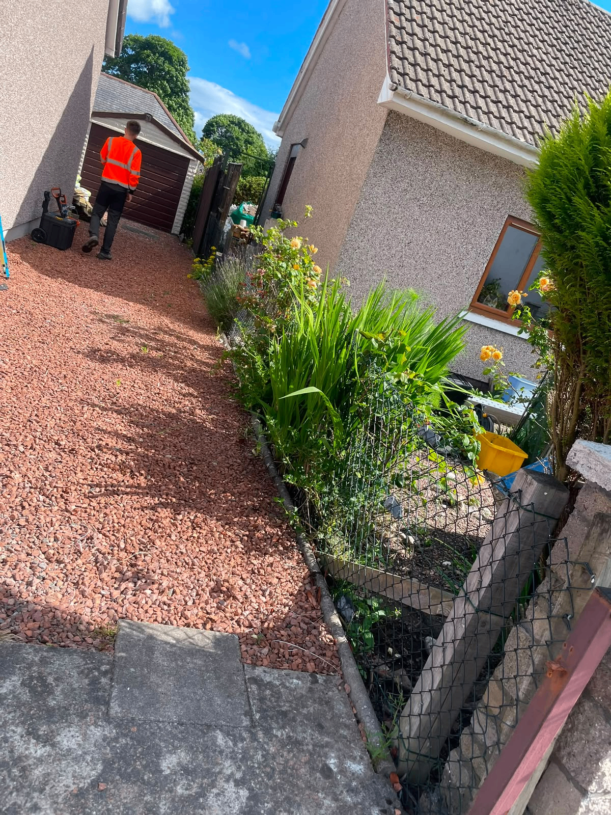 Side path cleared and re-dressed with red gravel, before