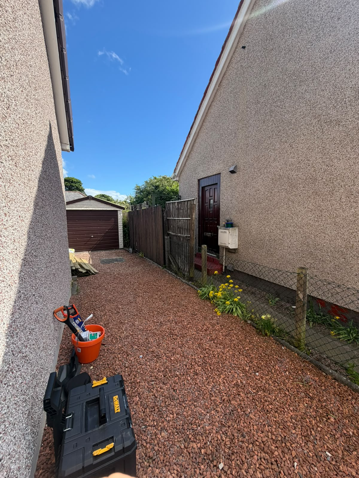 Side path cleared and re-dressed with red gravel, after
